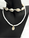 Boho Shell Bead Necklace SetEmbrace the spirit of summer with this boho-inspired shell bead necklace set. Featuring two coordinating necklaces, one with natural cowrie shells and the other with delicate white beads and a single shell pendant, this set captures the laid-back beachy vibe. Perfect for layering or wearing individually, these necklaces add a touch of coastal charm to any casual outfit.