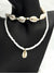 Boho Shell Bead Necklace SetEmbrace the spirit of summer with this boho-inspired shell bead necklace set. Featuring two coordinating necklaces, one with natural cowrie shells and the other with delicate white beads and a single shell pendant, this set captures the laid-back beachy vibe. Perfect for layering or wearing individually, these necklaces add a touch of coastal charm to any casual outfit.