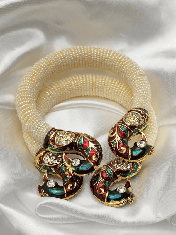 Gold-toned braceletpeacock braceletDesigner enamel braceletTraditional jewelryFestive accessoriesWedding braceletLuxury handmade braceletEnamel and rhinestone jewelryUnique braceletFashionable Indian jewelry