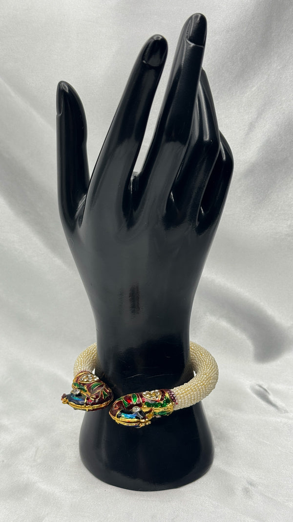 Gold-toned braceletpeacock braceletDesigner enamel braceletTraditional jewelryFestive accessoriesWedding braceletLuxury handmade braceletEnamel and rhinestone jewelryUnique braceletFashionable Indian jewelry