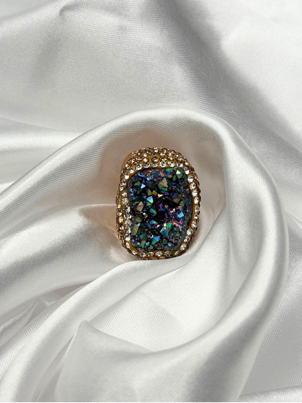 Earthy, reminiscent, bold design, oceanic blue hue center stone surrounded by textured, gold-toned settingone size fits allstatement ringvacation ring bold ringunique designgold jewelry gold ring earthy ring