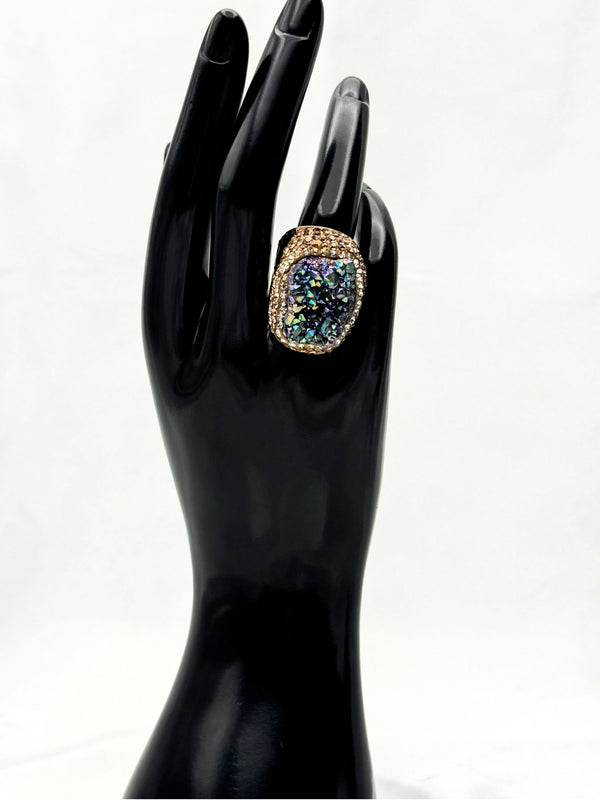 Earthy, reminiscent, bold design, gray hue center stone surrounded by textured, gold-toned settingone size fits allstatement ringvacation ring bold ringunique designgold jewelry gold ring earthy ring