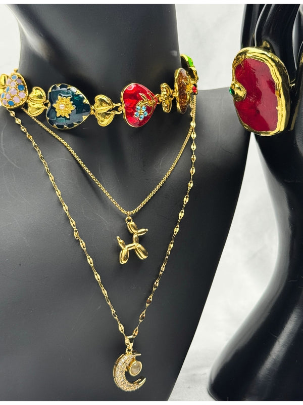 Multicolor heart charm chokerLayered pendant necklace setCrescent moon charm necklaceRed gemstone statement ringEnchanted jewelry set for womenPlayful and elegant jewelry collectionUnique charm jewelry setBoho chic layered necklace