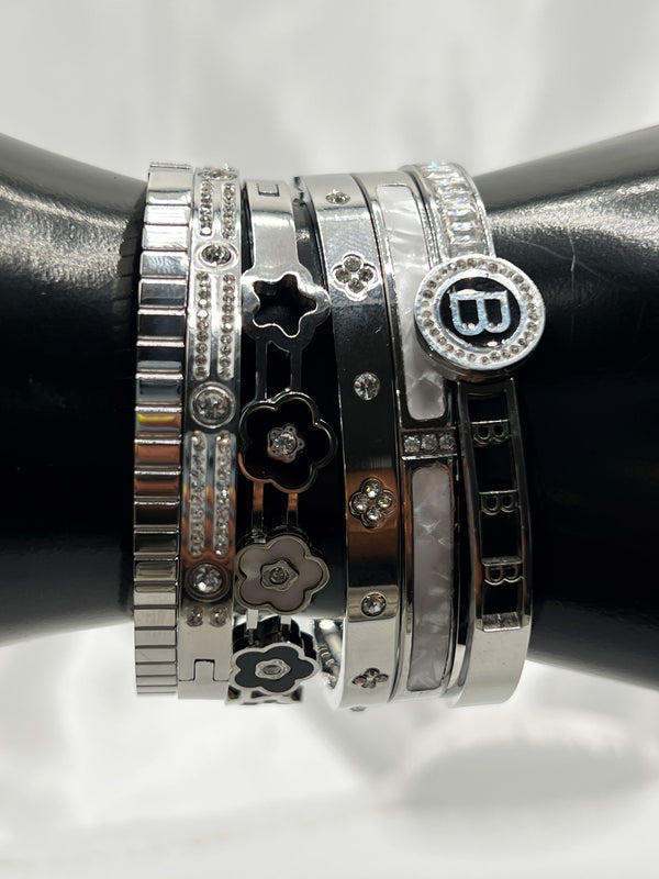 Silver bangle stackFloral motif banglesCrystal embellished braceletsElegant silver jewelryWomen's bangle setFashionable silver-toned banglesSophisticated bracelet stackStylish wrist accessoriesChic silver bangles
