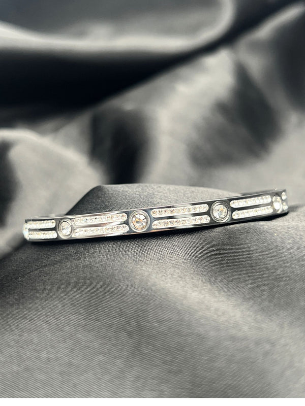 Silver bangle stackFloral motif banglesCrystal embellished braceletsElegant silver jewelryWomen's bangle setFashionable silver-toned banglesSophisticated bracelet stackStylish wrist accessoriesChic silver bangles