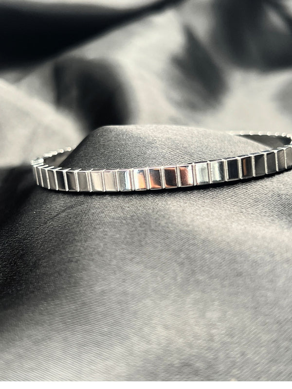 Silver bangle stackFloral motif banglesCrystal embellished braceletsElegant silver jewelryWomen's bangle setFashionable silver-toned banglesSophisticated bracelet stackStylish wrist accessoriesChic silver bangles