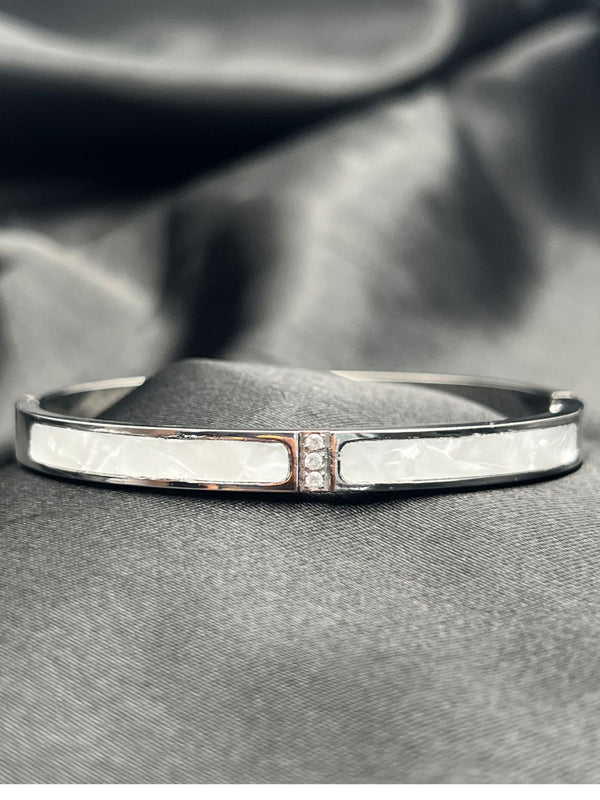 Silver bangle stackFloral motif banglesCrystal embellished braceletsElegant silver jewelryWomen's bangle setFashionable silver-toned banglesSophisticated bracelet stackStylish wrist accessoriesChic silver bangles