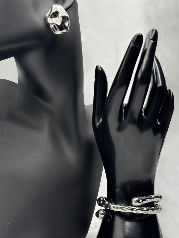 Silver sculpted earringsTwisted silver bangle braceletModern statement jewelry setOrganic shape earringsContemporary silver jewelryBold silver earrings and braceletArtistic jewelry set for women