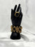 Gold and black statement braceletBold jewelry setBlack stone ring and bracelet setElegant gold jewelryWoven gold braceletBlack accent statement jewelryFashion jewelry setLuxurious evening accessories