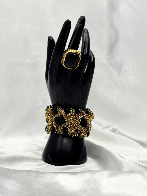 Gold and black statement braceletBold jewelry setBlack stone ring and bracelet setElegant gold jewelryWoven gold braceletBlack accent statement jewelryFashion jewelry setLuxurious evening accessories