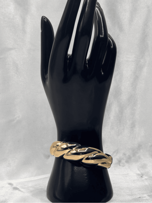 Gold ripple braceletBold statement braceletModern gold bangleLuxurious gold-tone jewelryRipple design braceletChunky gold bracelet for womenElegant wrist accessoriesContemporary statement jewelryStylish gold arm jewelryVersatile gold bangle bracelet