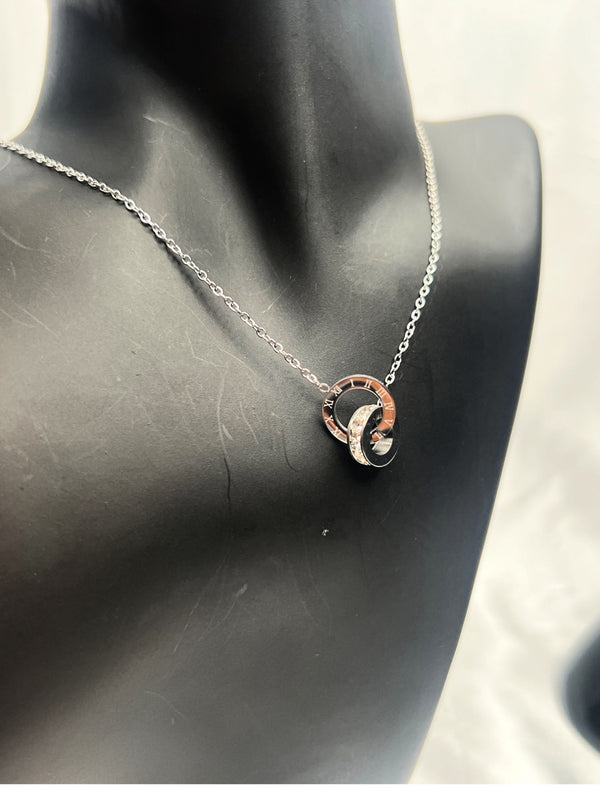 minimalist silver jewelry set, double-ring pendant necklace, Roman numeral bracelet, silver stud earrings, modern jewelry ensemble, sleek silver accessories