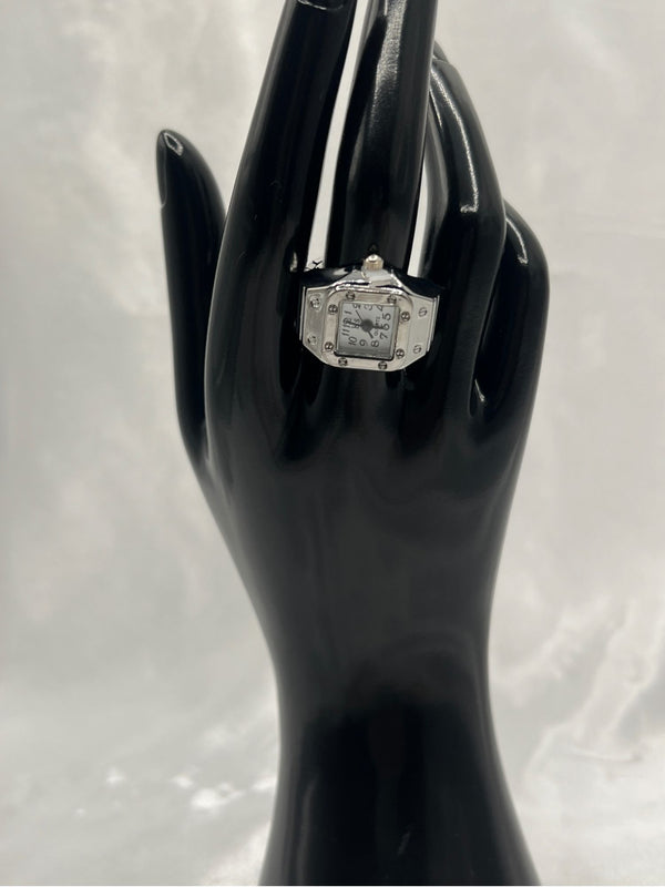 Silver-Tone Watch Ring with White Face. Unique, silver-tone, watch ring, featuring a chic square face with clear, easy-to-read black numerals. Combining the functionality of a watch with the elegance of a ring. Ffashion with a practical twist. silver-tone watch ringsquare face watch ringstylish watch ring for womenrhinestone watch ringelegant watch ring with white dialfunctional jewelryquartz watch ringstatement timepiece jewelrywomen’s fashion ring watchunique silver-tone ring. One-size.