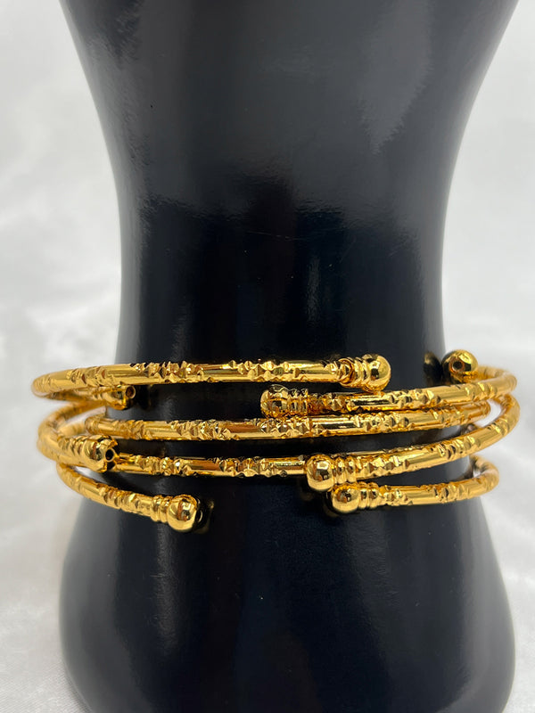 layered gold bangles, textured gold bracelets, elegant bangle set, stylish stacked bangles, women’s gold wrist jewelry, fashion bangles set, versatile gold