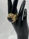 deep bllue stone encased in intricate, textured gold setting. Earthy feel. bold statement ringone size ringdeep blue stonetextured gold settingnatural designunique ring
