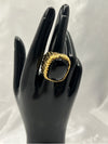  black and gold statement ring featuring a bold, square-shaped black stone framed in a textured gold band, glossy black stone and the intricate gold detailing standout pieceunique, high-impact jewelry.Black and gold statement ringBold black stone ringSquare black stone ringTextured gold ringChunky gold ring