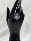 vintage-style silver-tone watch ring. Ornate bezel with intricate detailing. The round white dial with clear black numerals provides easy readability. Antique-inspired design. Perfect for vintage jewelry lovers who appreciate a statement piece with a practical twist.vintage-style watch ringsilver-tone watch ringornate bezel ring watchantique-inspired watch ringwomen’s fashion ring watchfunctional jewelry with vintage designquartz ring watch for womenstylish timepiece ringunique silver watch ring